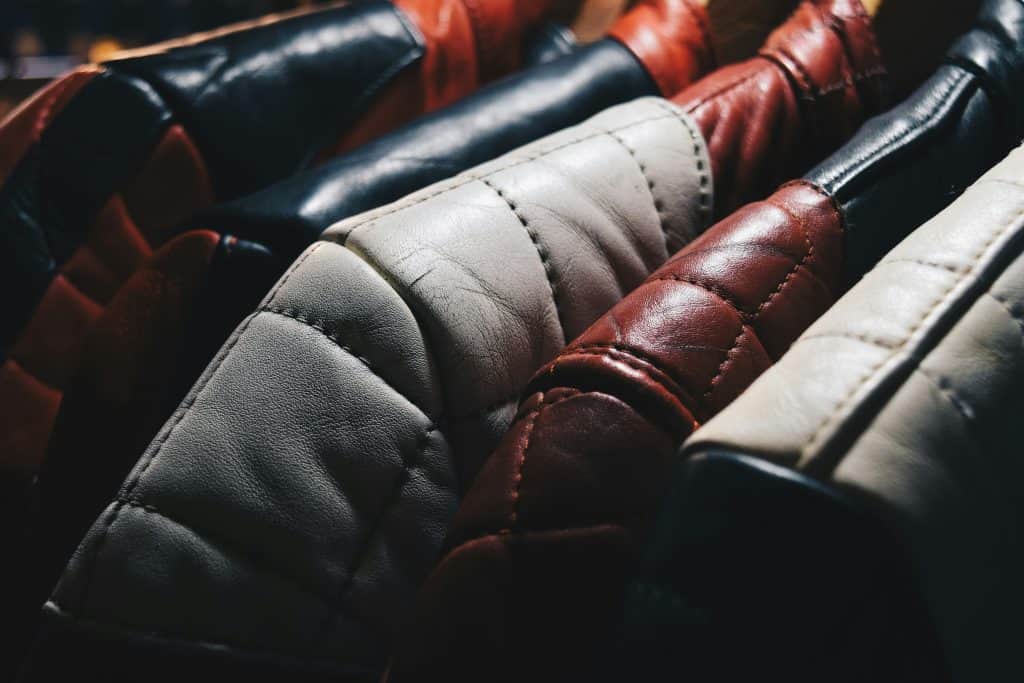 leather motorcycle jackets hanging on a rod